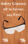 Safety glasses with text 'Safety Glasses: All in favour, say Eye!' on a wooden background.